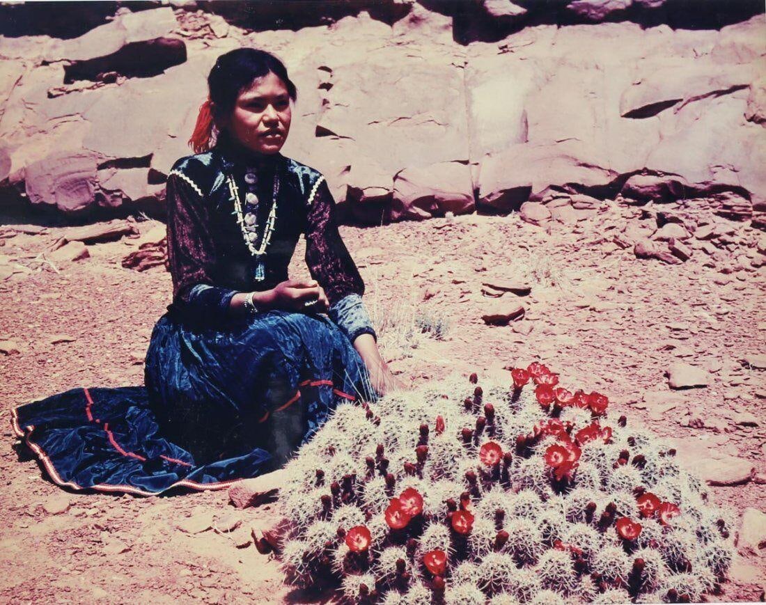 Josef Muench (American 1904-1998) Color Photograph Navaho Girl with Cactus: Muench, Josef (1904-1998) Color Study, Photographic print, 'Girl with Cactus' No.M-9742. Signed in Pen 'Josef Muench' lower right on mat board. Young Navajo girl with cactus in bloom. Photo of artist 