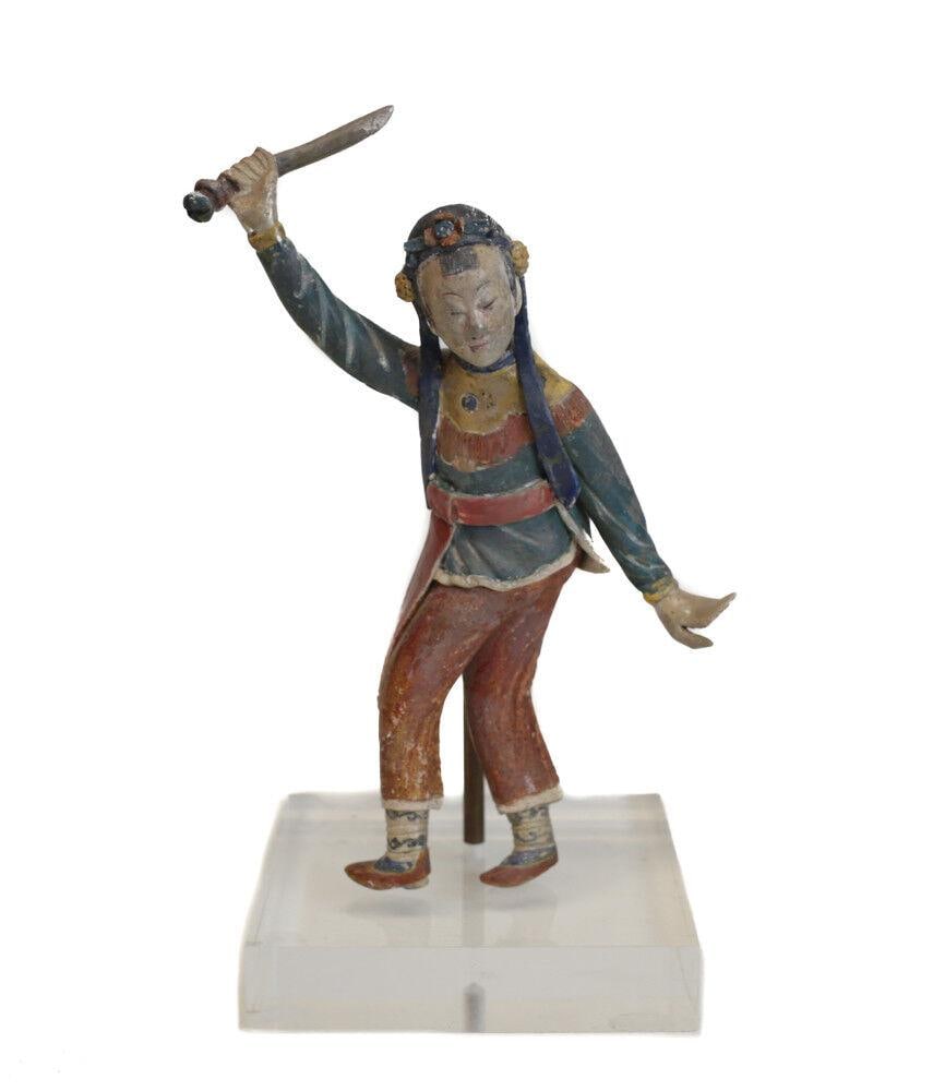 19th c Chinese Polychrome Stucco Roof Figure female character in green, yellow: 19th century Chinese Polychrome Stucco Glazed Roof Figure, female character in green, yellow and red tunic and red trousers, floral headband, holding sword or baton. On metal and acrylic mount. 1.5Lbs