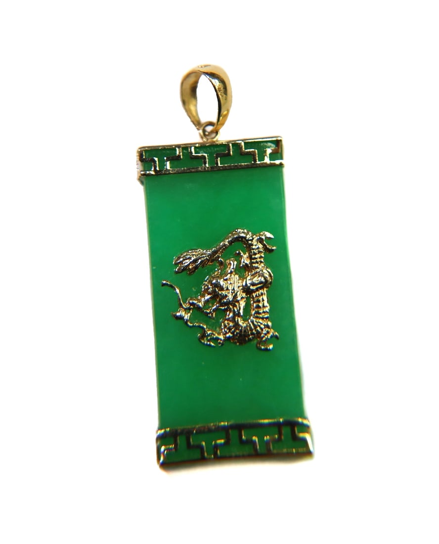 14k Yellow Gold and Green Jade Dragon Pendant: 14k yellow gold and green jade dragon pendant. Rectangular jade with an applied dragon to center and greek key frame to top and base. Marked 14k with maker mark PTJ to hook. Weight: Approx. 3.66 grams