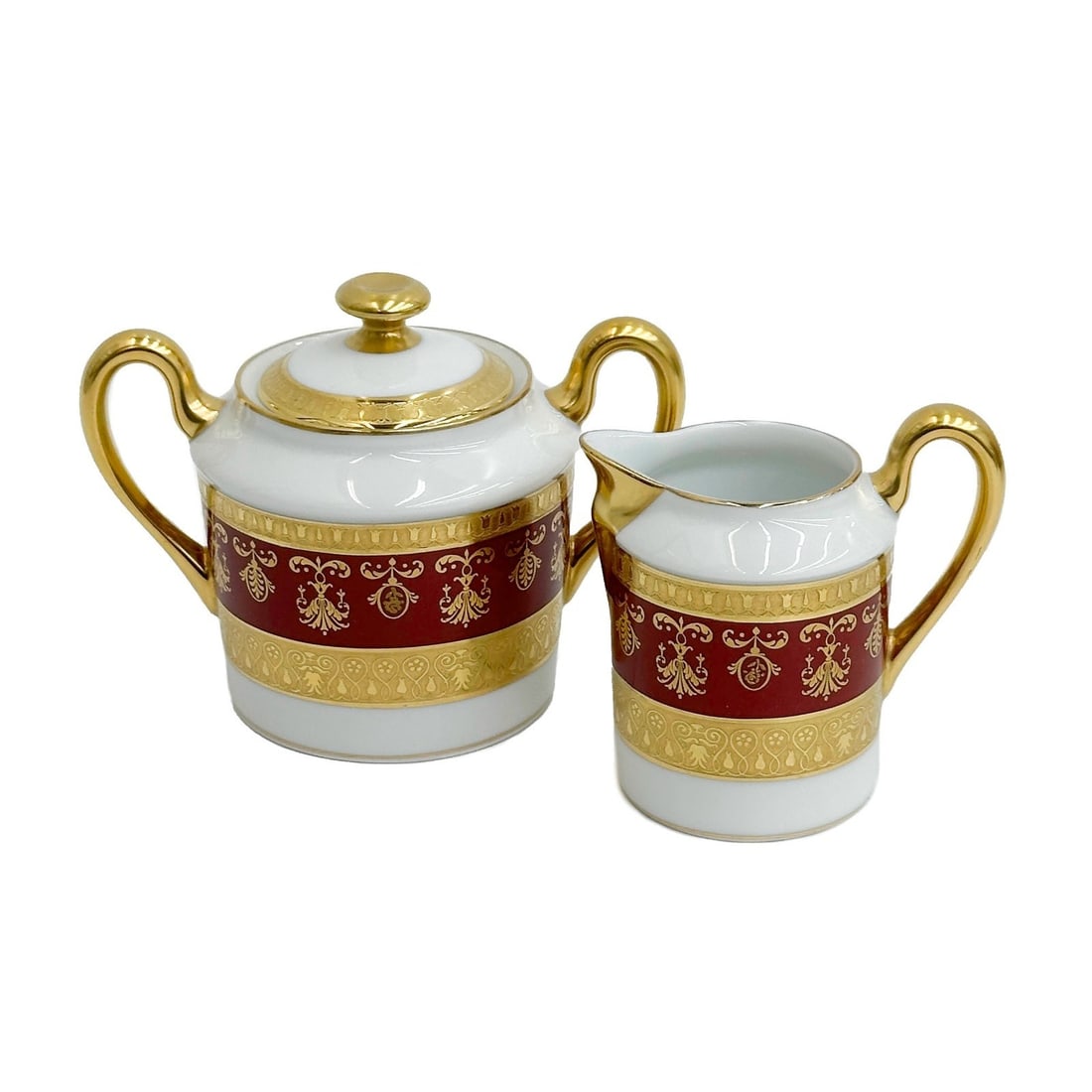 Raynaud Limoges France Gilt Porcelain Creamer & Sugar Bowl in Eugenie Rouge: Raynaud Limoges France Gilt Porcelain Creamer and Sugar Bowl in Eugenie Rouge. A burgundy red band with ornate gilt decoration, raised accents. Underside marked Raynaud Limoges "Eugenie"From the Prest