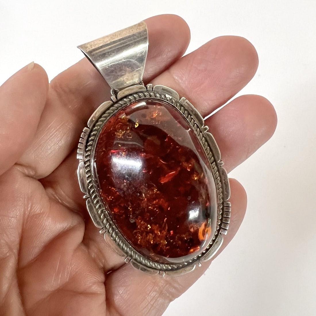 Large Vintage Navajo Sterling Silver cognac amber Pendant c1970: Navajo Sterling Silver cognac amber Pendant, with mark of the Sun West Silver Co. Albuquerque and the initials WY, marked sterling. c1970 Measurements: Approx. 30.61grams; 1.5 x 2.625 inches including