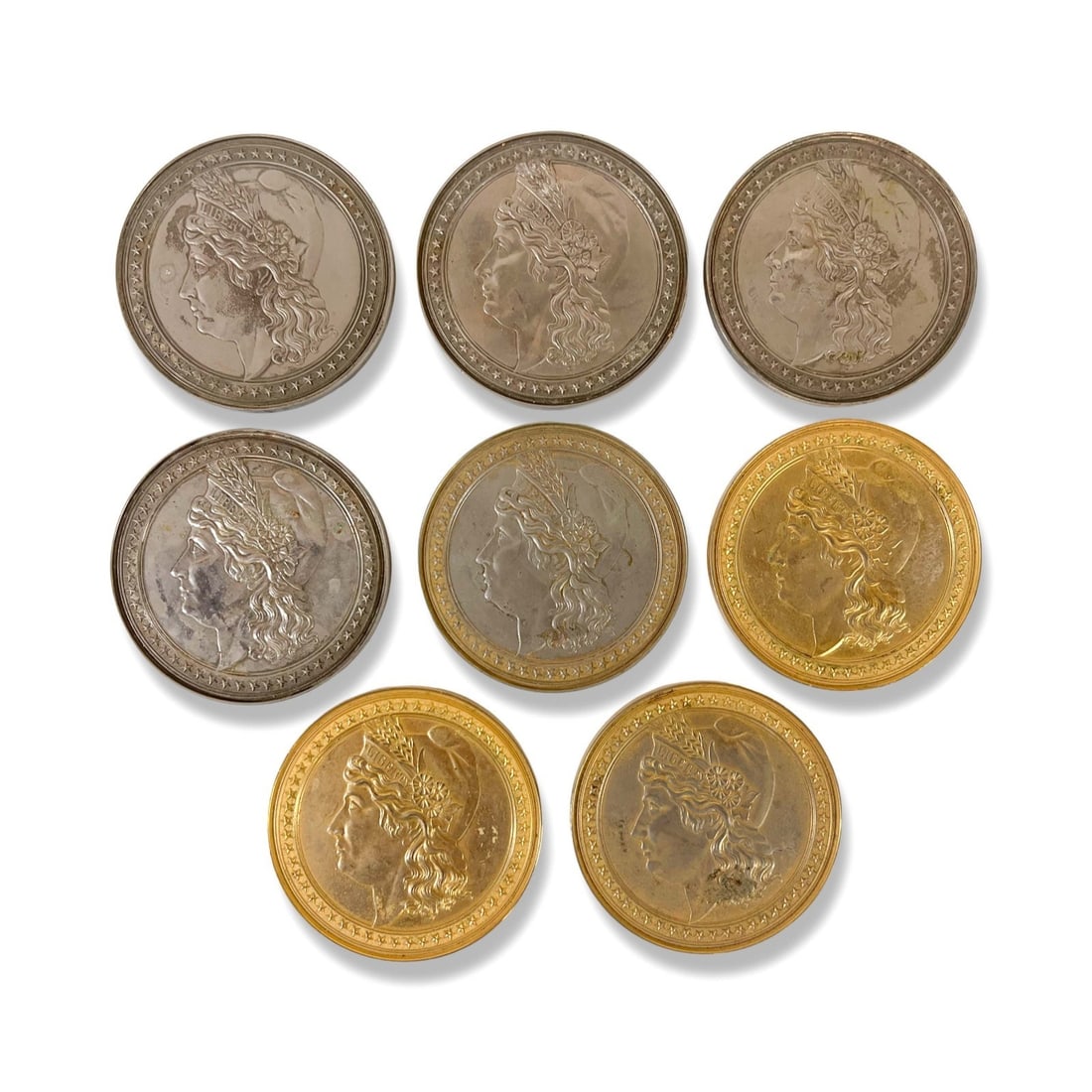 8 Vintage Lady Liberty Head Coasters silver and gold tone: a set of 8 Vintage Lady Liberty Head Coasters, silver and gold tone, with cork backing. Heavy for size. Likely brass, non-magnetic. Measurements: Approx. 3.5 inches diameter x 0.25 inches Condition: G