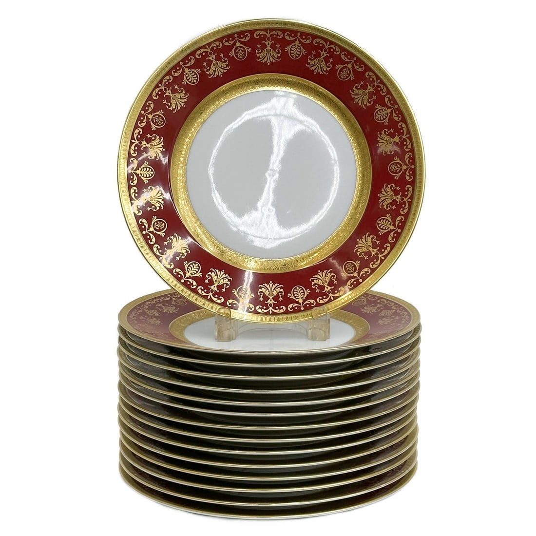 15 Raynaud Limoges France Gilt Porcelain 10.75in Dinner Plates in Eugenie Rouge: 15 Raynaud Limoges France Gilt Porcelain Dinner Plates in Eugenie Rouge. A burgundy red ground to the edge with ornate gilt decoration, raised accents. Underside marked Raynaud Limoges "Eugenie"From t