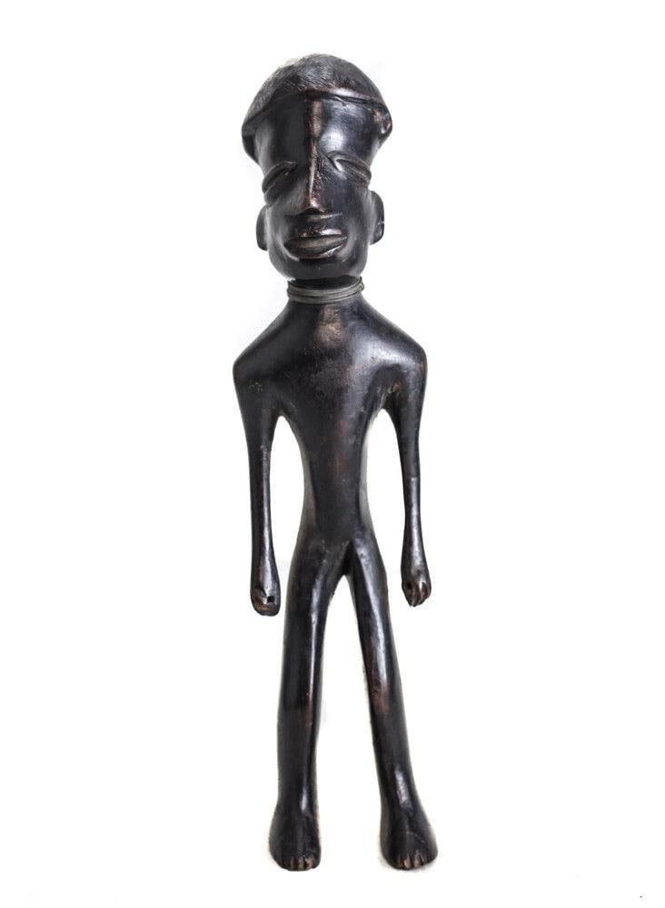 African Carved Wood Figure Makonde Standing man with wire neck ornament: African Carved Wood Figure, Makonde Standing man with wire neck ornament. Domed hair style, holes are in his fists - no additional ornaments or staffs. Very dark black wood. 1lb Measurements: Approx. 
