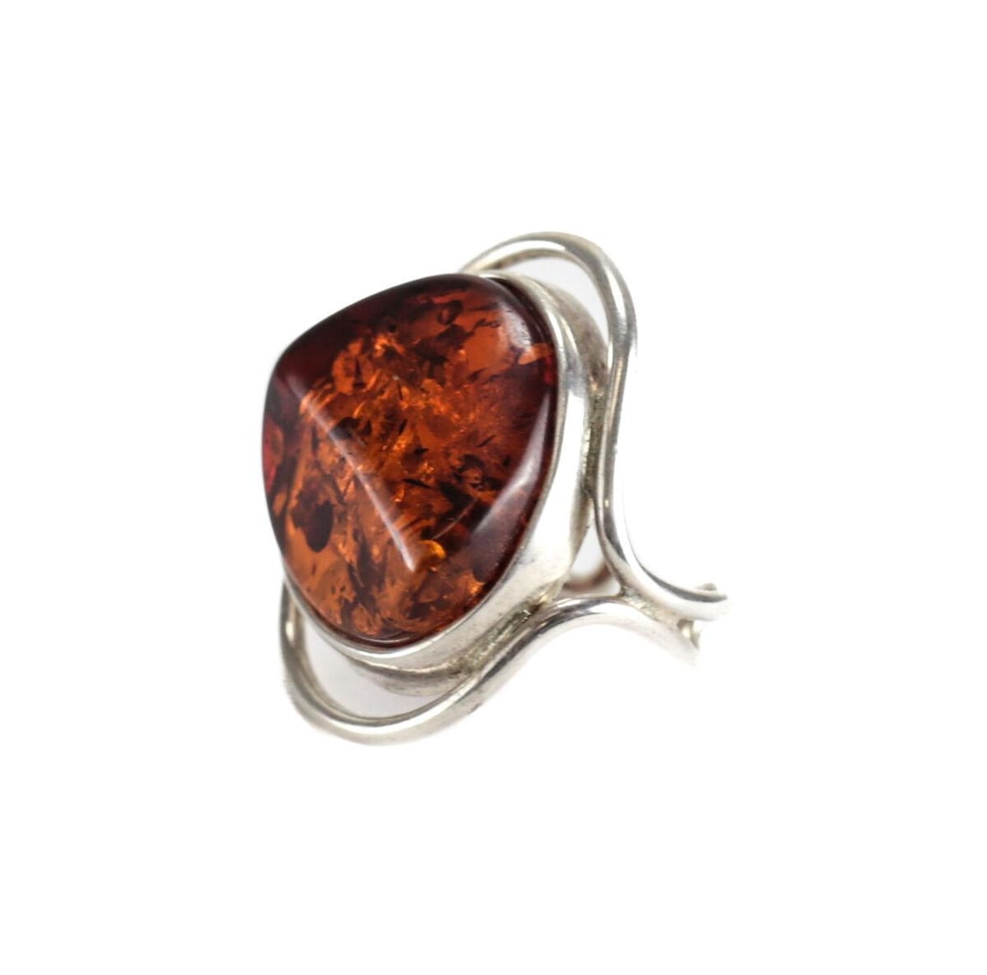 LARGE Baltic Amber Cabochon Sterling Silver Modernist Statement Ring Adjustable: Baltic Amber Cabochon Sterling Silver Modernist Statement Ring Adjustable, currently sized to 7.25. Asymmetrical stone, Unmarked, tested silver. 9.5grams Measurements: Approx. stone 18mm x 20mm; ring 