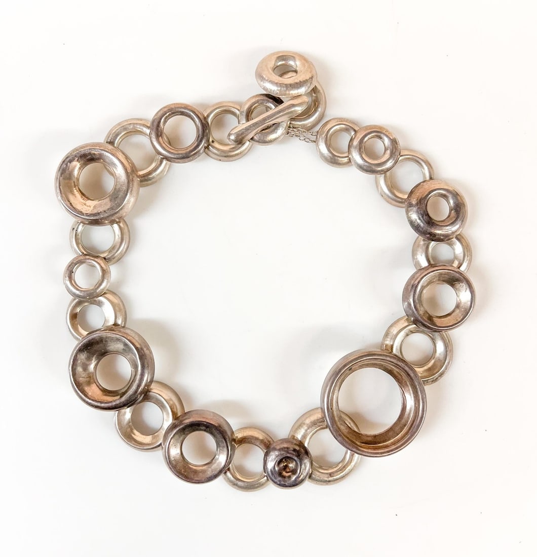 Vintage Sterling Silver Modernist Artisan Necklace Disk Ring Necklace: Vintage Sterling Silver Modernist Artisan Necklace Disk Ring Necklace, articulated donut shaped rings, with a toggle closure which allows for some adjustment to the length. Unmarked, tested silver. Me