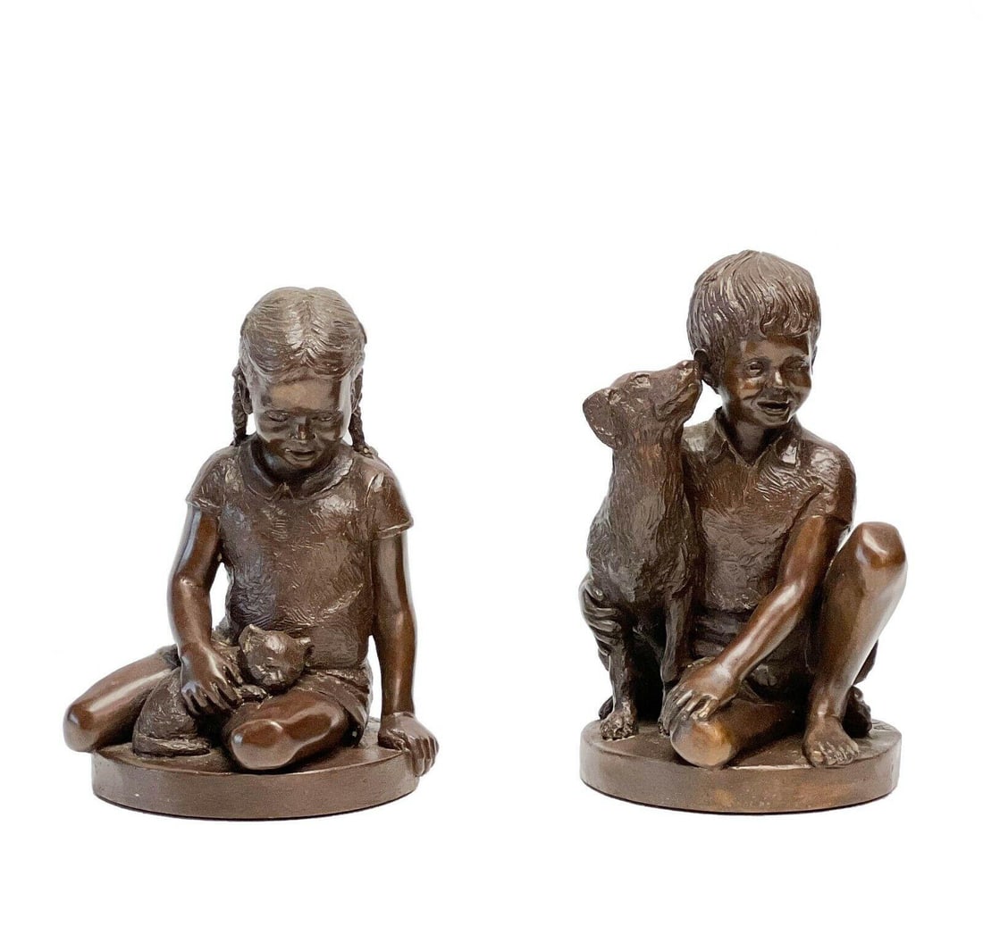 Charles Parks Pair Patinated Bronze Boy & Girl with Cat Sculptures Signed: Pair patinated bronze boy and girl sculptures by Charles Parks (American, 1922-2012). Sculptures depict a girl sitting with a cat and a boy sitting with a dog. Inscribed Parks '74 to the back edge of 