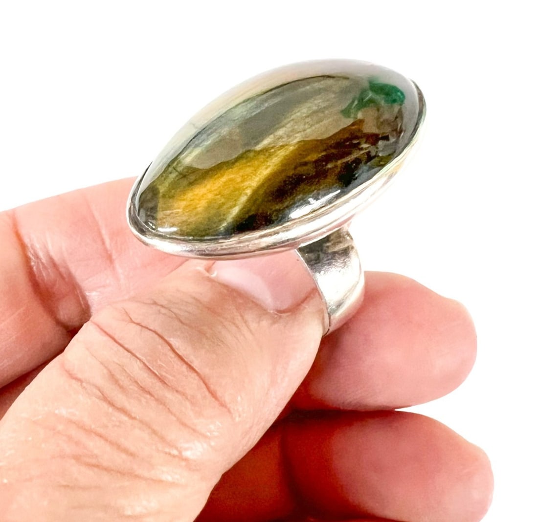 Vintage Modernist Israel Tiger Eye Sterling Silver Ring Sz 5: Vintage Modernist Israel Tiger Eye Sterling Silver Ring, Cabochon stone in a football shape, bezel set. Size 5. Marked "Hand made" and "Israel 925 ???." c1970. Measurements: Approx. 16.55grams; size 5