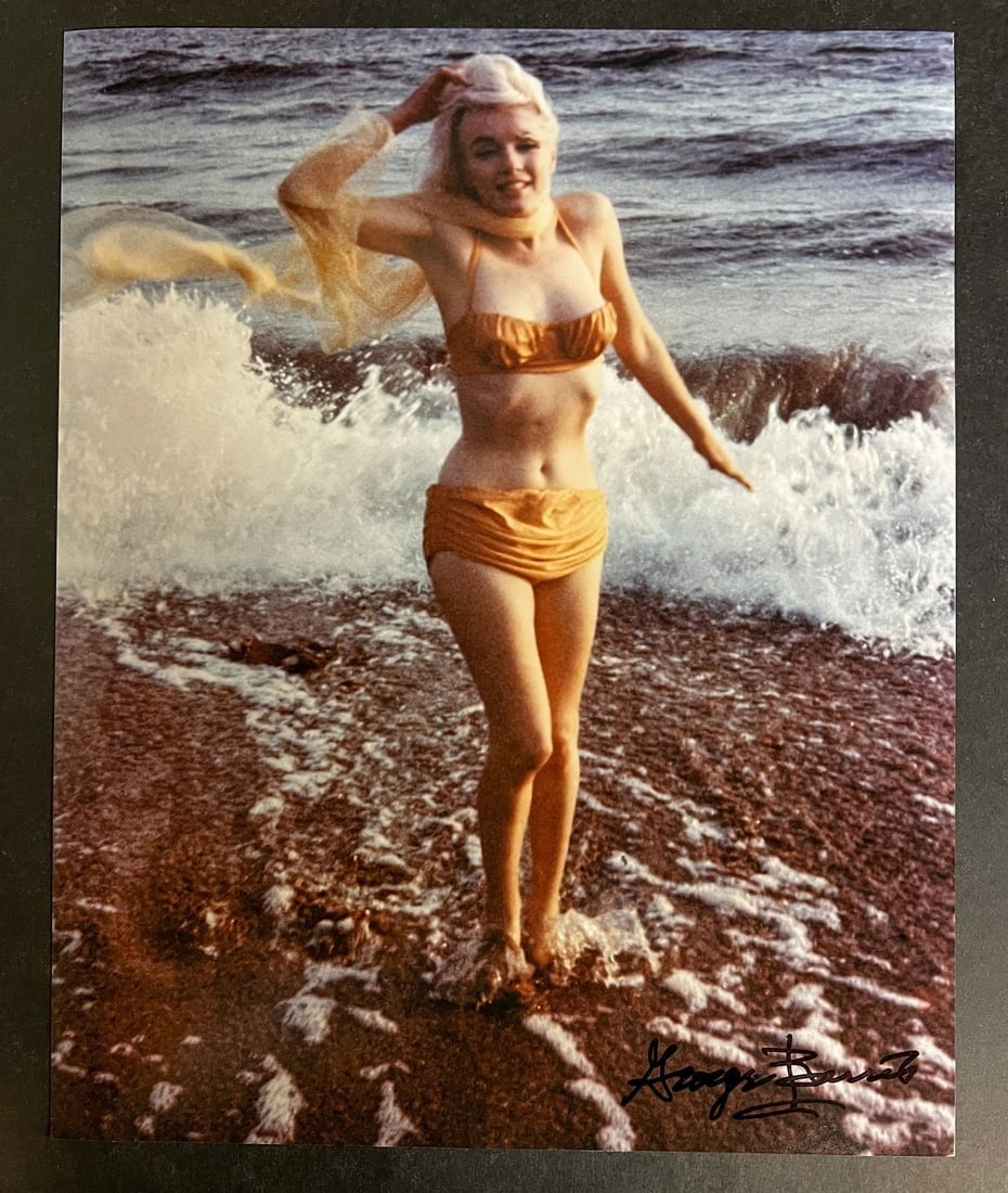Color Photograph Marilyn Monroe by George Barris: A limited edition George Barris photograph of Marilyn Monroe. Signed by George Barris in marker (lower right). Stamped and numbered on reverse. Marilyn Monroe at Santa Monica Beach in 1962, standing a