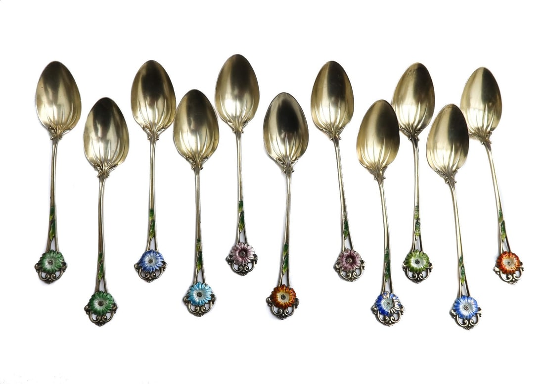 11 Whiting Gold Wash Sterling Silver and Enamel Floral Teaspoons: 11 Whiting gold wash sterling silver and enamel floral teaspoons. Multi-colored enamel florals to finials. Whiting silver mark to verso. Weight: Approx. 2.2 ozt Measurements: Approx.4 inches length Co