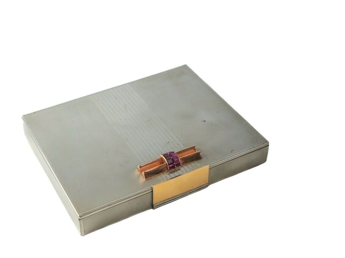 Van Cleef & Arpels Ruby Styptor Minaudiere Case c1935 18k Rose Gold Details: Van Cleef & Arpels Ruby Styptor Minaudiere Case c1935-40. Machined texture with reeded central panel. Stylish Art Deco design features rows of square-cut rubies at its 18k Rose gold clasp. Compartment