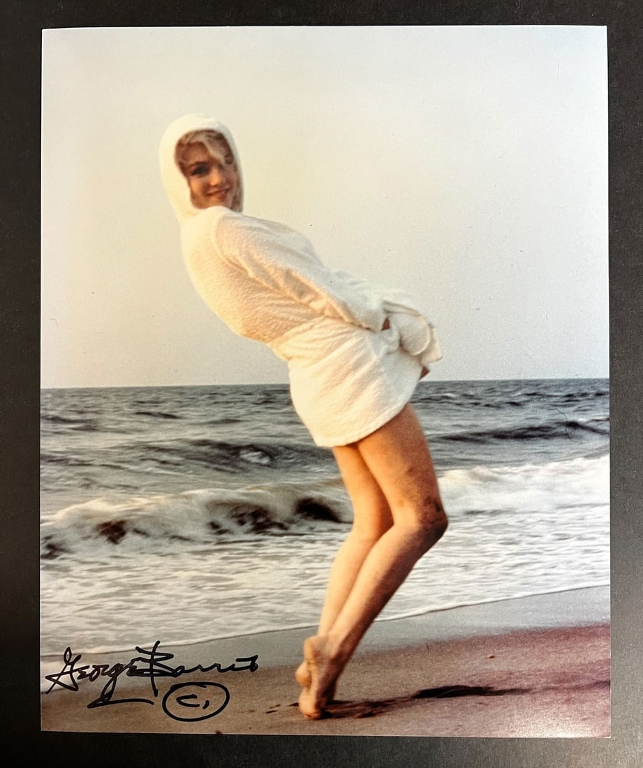 Color Photograph Marilyn Monroe by George Barris: A limited edition George Barris photograph of Marilyn Monroe. Signed by George Barris in marker (lower left). Stamped and numbered on reverse. Marilyn Monroe at Santa Monica Beach in 1962, dressed in 