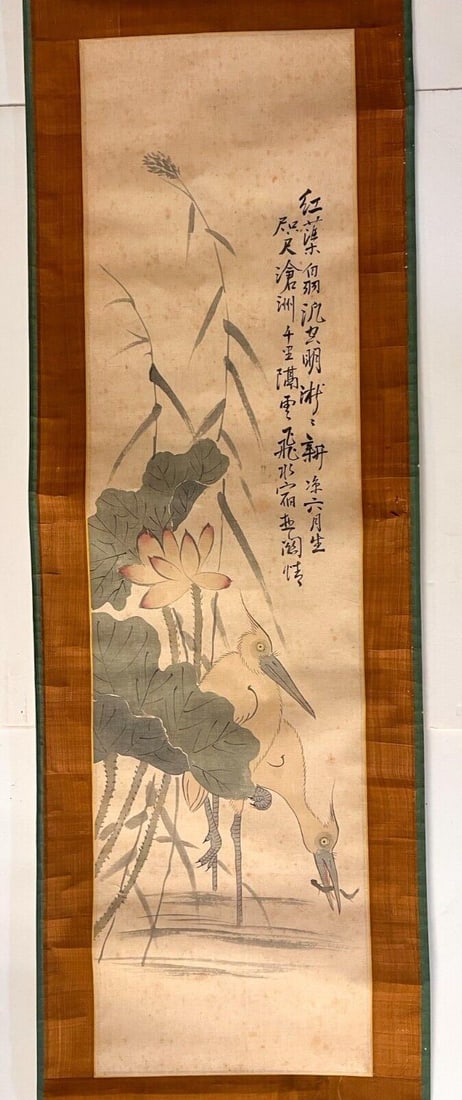 Antique Vertical Scroll painting Egrets and Lotus Blossoms: Chinese or Japanese Vertical Silk Scroll painting, mounted on paper with silk borders, color painting, Egrets in a landscape of water lilies, one having caught a fish. Calligraphy upper right. Porcela