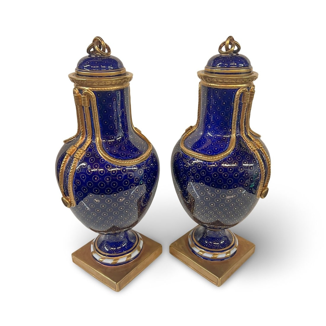 Pair of Chelsea House Cobalt and Gilt Decorated Porcelain Covered Urns: Pair of Chelsea House Cobalt and Gilt Decorated Porcelain Covered Urns, cobalt blue with hand painted gilt details. Makers marks on underside. Measurements: Approx. 15 x 6.5 x 6 inches Condition: Over