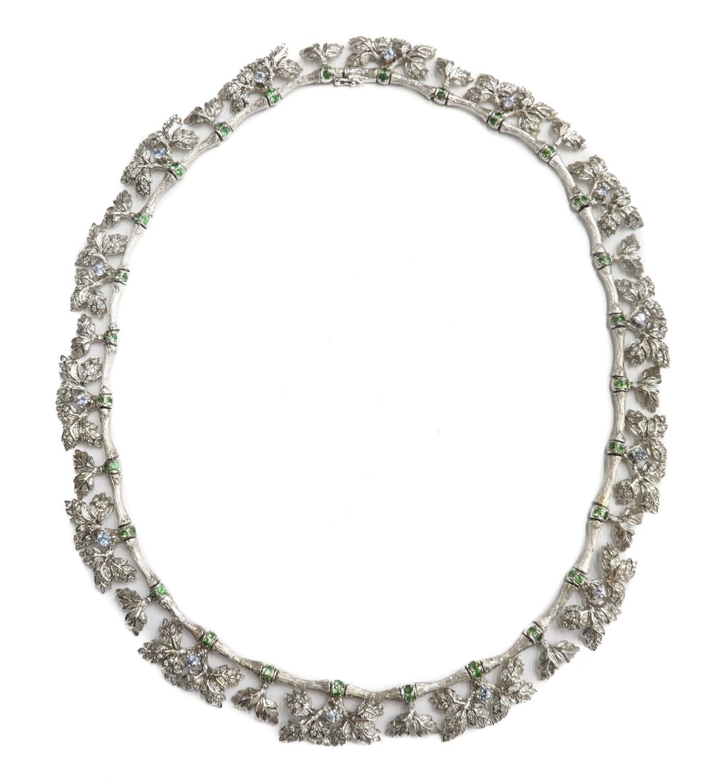 20k White Gold Diamond Green Garnet and Light Blue Sapphire Leaf Necklace: 20k white gold diamond, green garnet, and light blue sapphire leaf necklace. Approximately 224 round cut diamonds to the leaves of the necklace weighing around 1.5 carats. 56 green garnets measuring 2