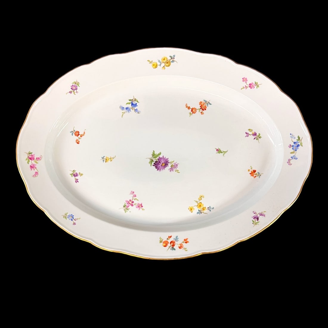 Meissen Scattered Flowers Oval Serving Platter 19": Meissen Scattered Flowers Oval Serving Platter, hand painted flowers, cross sword mark 5.3lbs Measurements: Approx. 19.125 x 14 x 2 inches Condition: Very good condition, no chips or cracks, some disc
