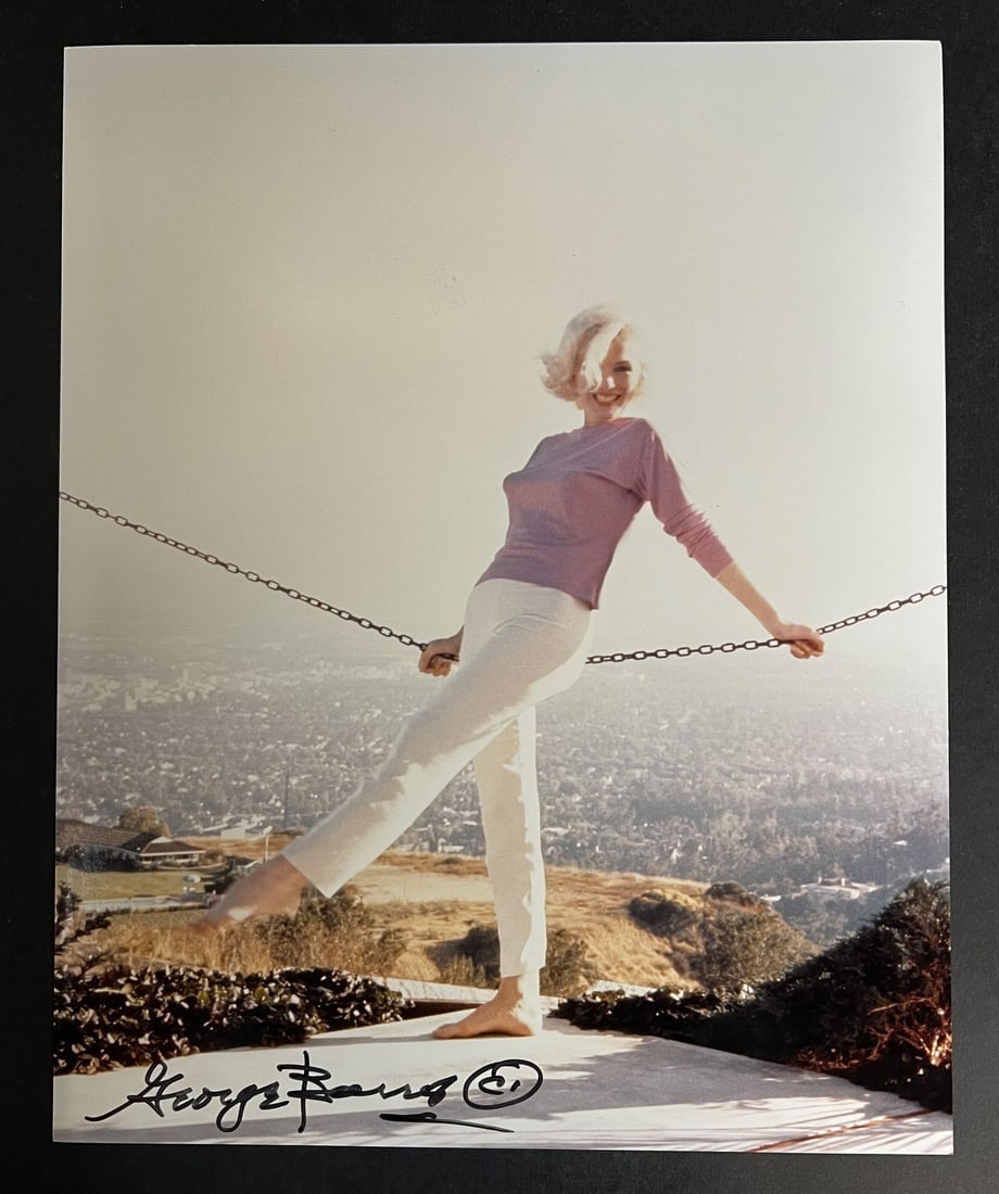 Color Photograph Marilyn Monroe by George Barris: A limited edition George Barris photograph of Marilyn Monroe. Signed by George Barris in marker (lower left). Stamped and numbered on reverse. Marilyn Monroe at her home in 1962. This is from a set of