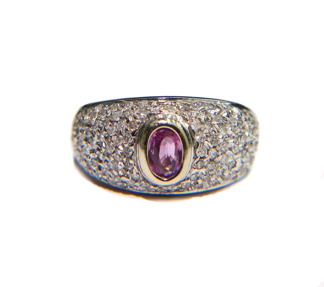 14k White Gold Diamond and Pink Sapphire Dome Ring Size 8: 14k white gold diamond and pink sapphire dome ring, size 8. Pink sapphire to center measuring approximately 6mm x 4mm and weighing around 0.65 carats. 96 round cut diamonds surrounding the sapphire me