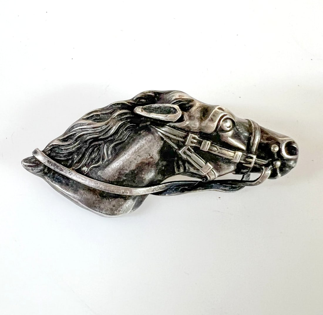 Victorian Sterling Silver Horse Head Equestrian Brooch: Victorian Sterling Silver Horse Head Equestrian Brooch, marked Sterling. c1900. C closure. Measurements: Approx. 4.90grams; 1.75 x 0.75 inches Condition: Good condition, signs of use, oxidation, sligh