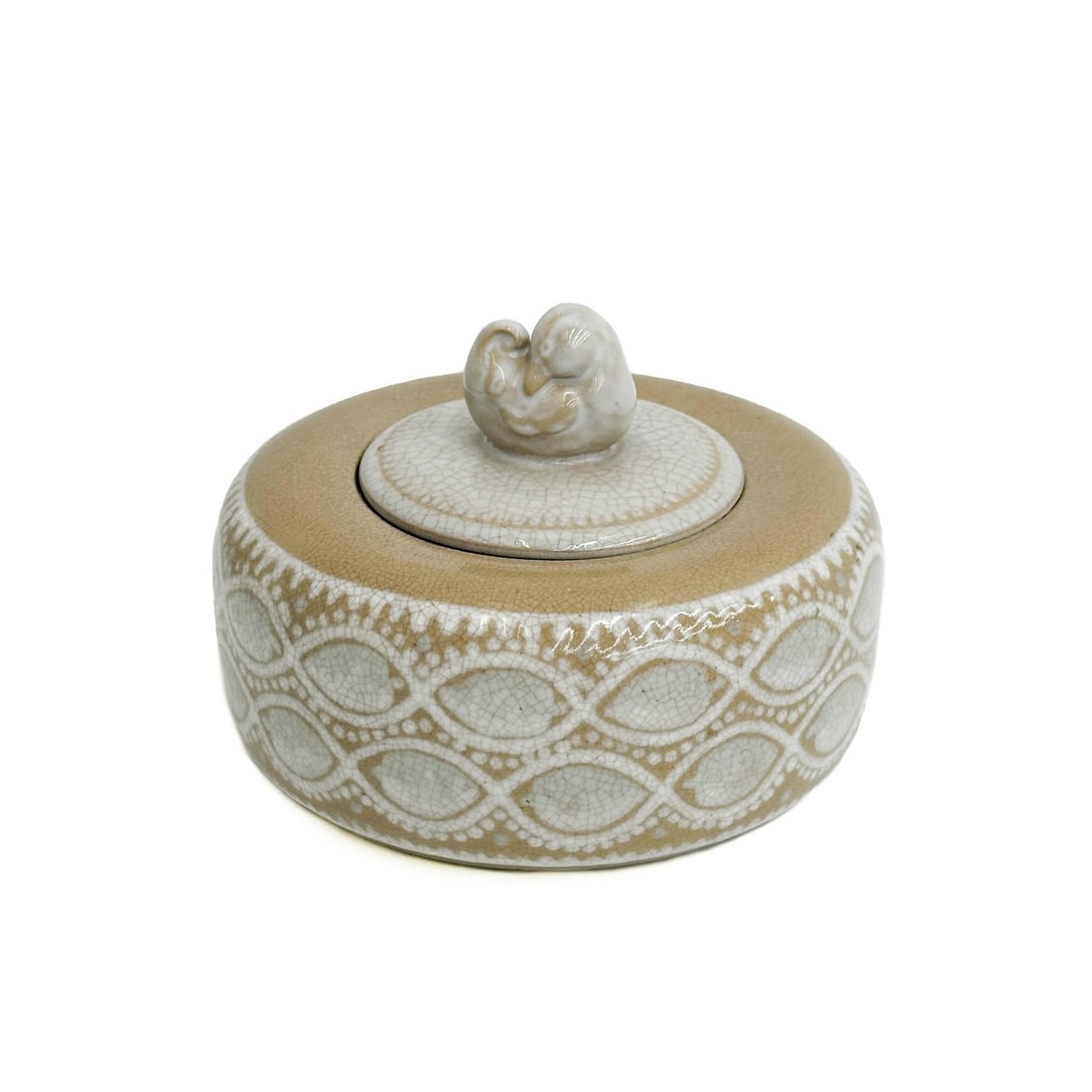 Maurice Gensoli for Manufacture Nationale de Sevres Glazed Faience Covered Box: Maurice Gensoli for Manufacture Nationale de Sevres Glazed Faience Covered Box, 1927. Glazed round box with a tan ground, blue and white designs to exterior. Cover with figural bird finial. Underside 