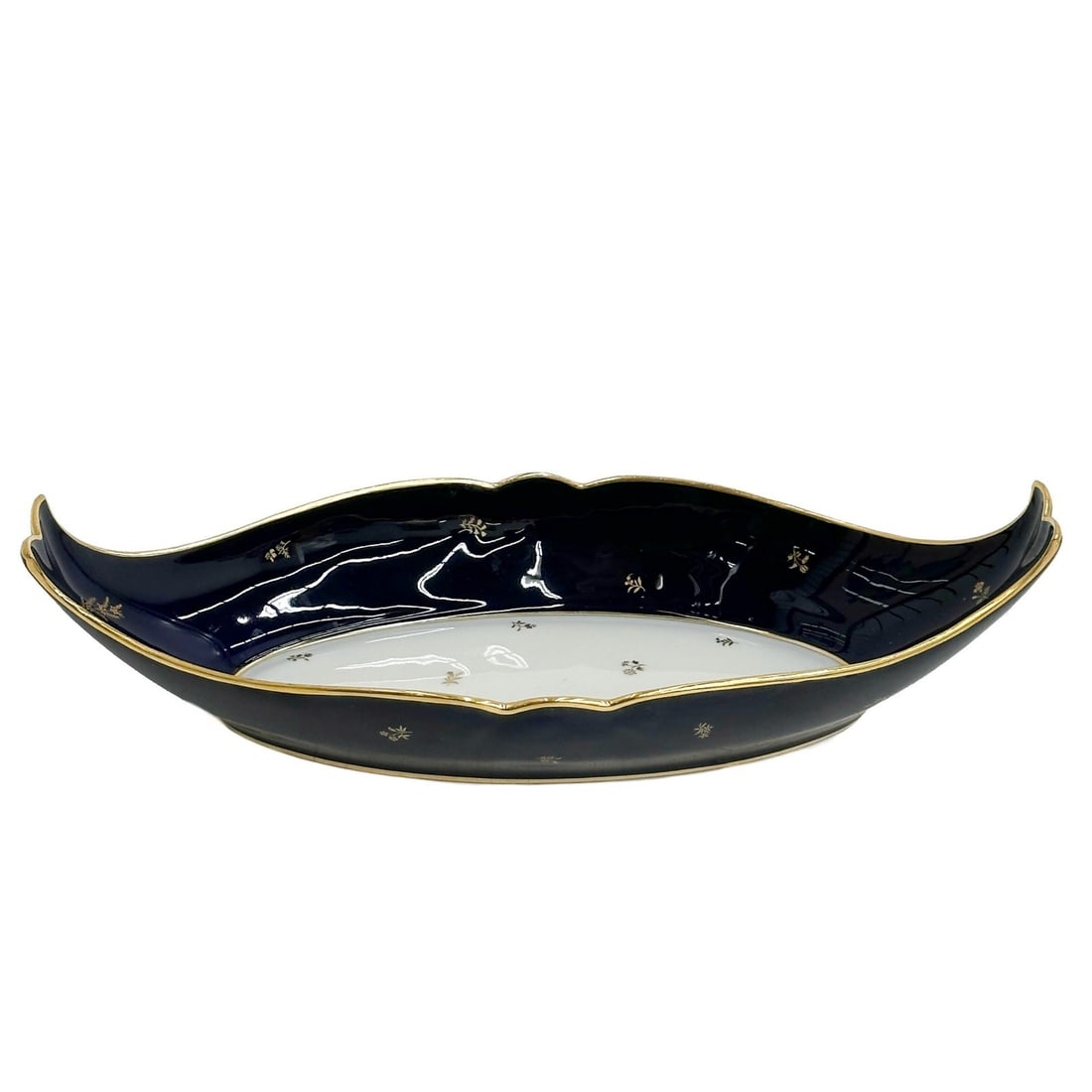 Manufacture de Sevres Cobalt Blue & Gilt Porcelain Oval Serving Dish 1945: Manufacture de Sevres France Porcelain Oval Serving Dish. A cobalt blue ground to the edge with gilt floral accents. Underside with Sevres marks, date mark for 1945. Weight: Approx. 1 lb Measurements: