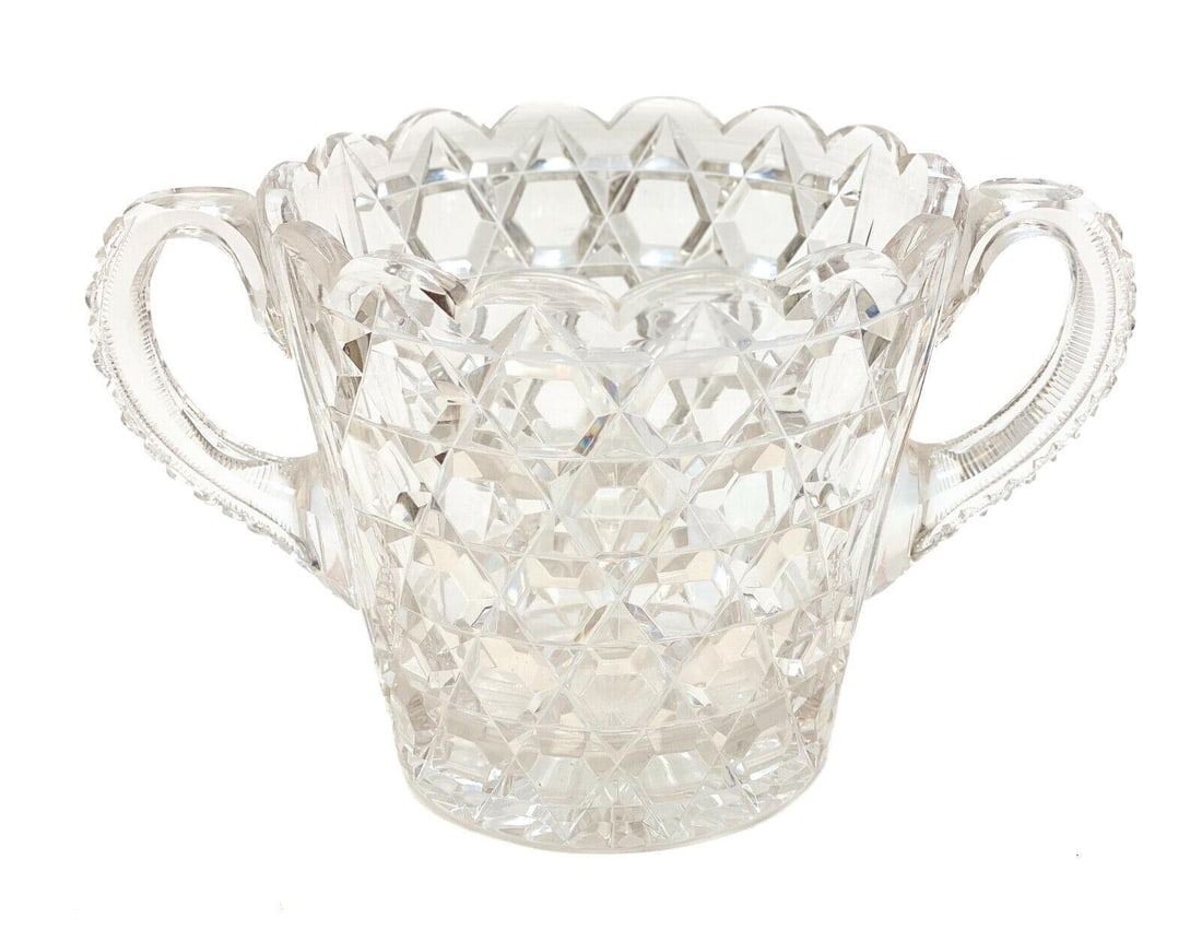 Continental Cut Glass Double Handled Ice Bucket: Continental cut glass double handled ice bucket. Cut glass diamond designs throughout with a scalloped rim. Weight: Approx. 2 lbs Measurements: approx. 10 inches diameter x 7.5 inches x 8.5 inches tal
