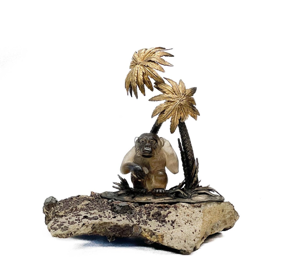 Sterling Silver and Carved Smoky Quartz Ape Sculpture by Gianmaria Buccellati: An incredible sculpture by Gianmaria Buccellati consisting of a realistically modeled carved smoky quartz hardstone in the form of an ape, in the manner of Faberge, sitting atop a tropical terrain cas