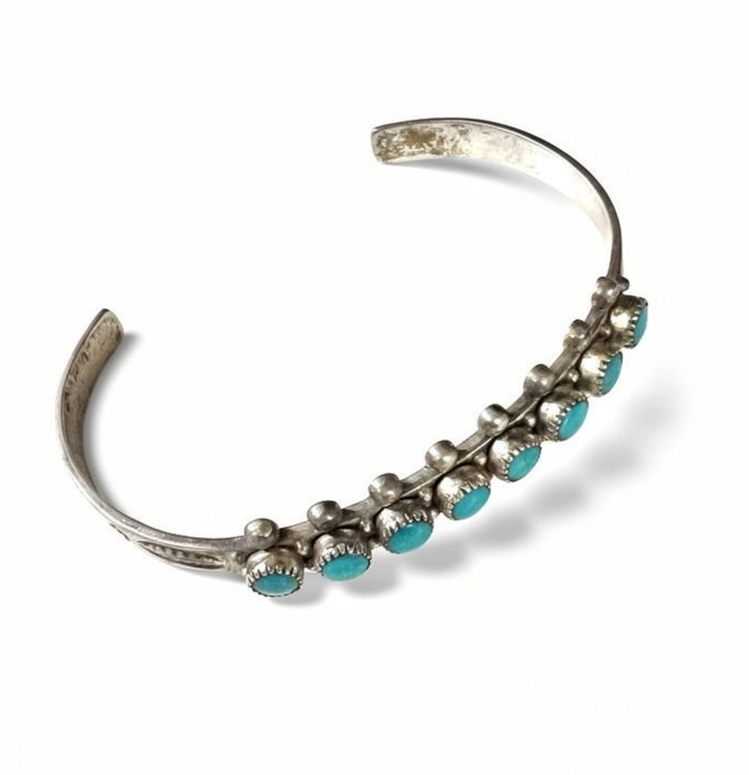 Native American Zuni Petite Point Sterling Silver and Turquoise Cuff Bracelet: Native American Zuni Snake Eye Sterling Silver and Petite point Turquoise Cuff Bangle Bracelet. Bright blue cabochon stones, stamped designs. Marked Sterling, c1960 Measurements: Approx. 8.62grams (0.