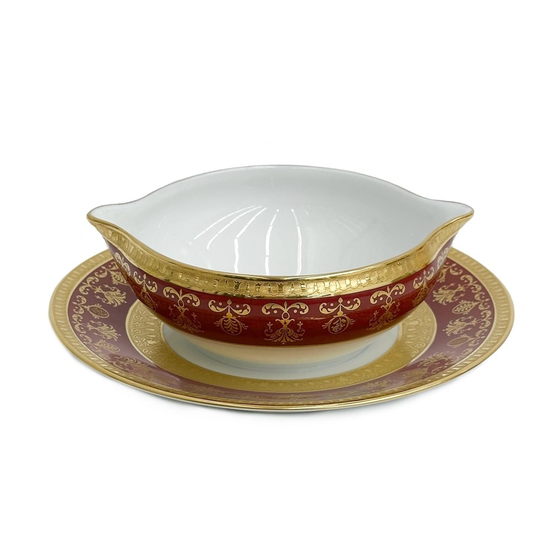 Raynaud Limoges France Gilt Porcelain Sauce Boat with Stand in Eugenie Rouge: Raynaud Limoges France Gilt Porcelain Sauce Boat with Stand in Eugenie Rouge. A burgundy red ground to the edge with ornate gilt decoration, raised accents. Underside marked Raynaud Limoges "Eugenie"F