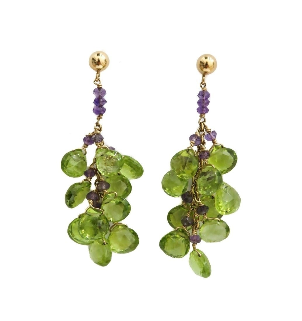 14k Yellow Gold Peridot and Amethyst Drop Earrings: 14k Yellow Gold Peridot and Amethyst Drop Earrings. Peridots and Amethysts in the form of grapes. The circle peridots measuring approx. 7.4mm x 6.5mm x 5mm. Marked 14k to clasp. Weight: Approx. 8.73 g