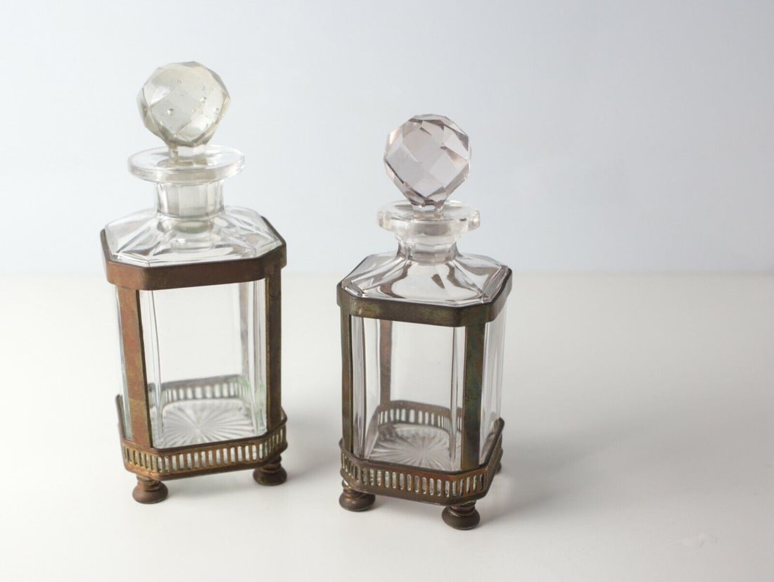 19th century Continental Footed Bronze mounted Crystal Perfume Scent Bottles: 19th Century Continental Bronze mounted Crystal Perfume Scent Bottles, Footed mounts with open pierced grill at the base. Faceted globe stoppers. Bottles have radiating star burst on the base, canted 