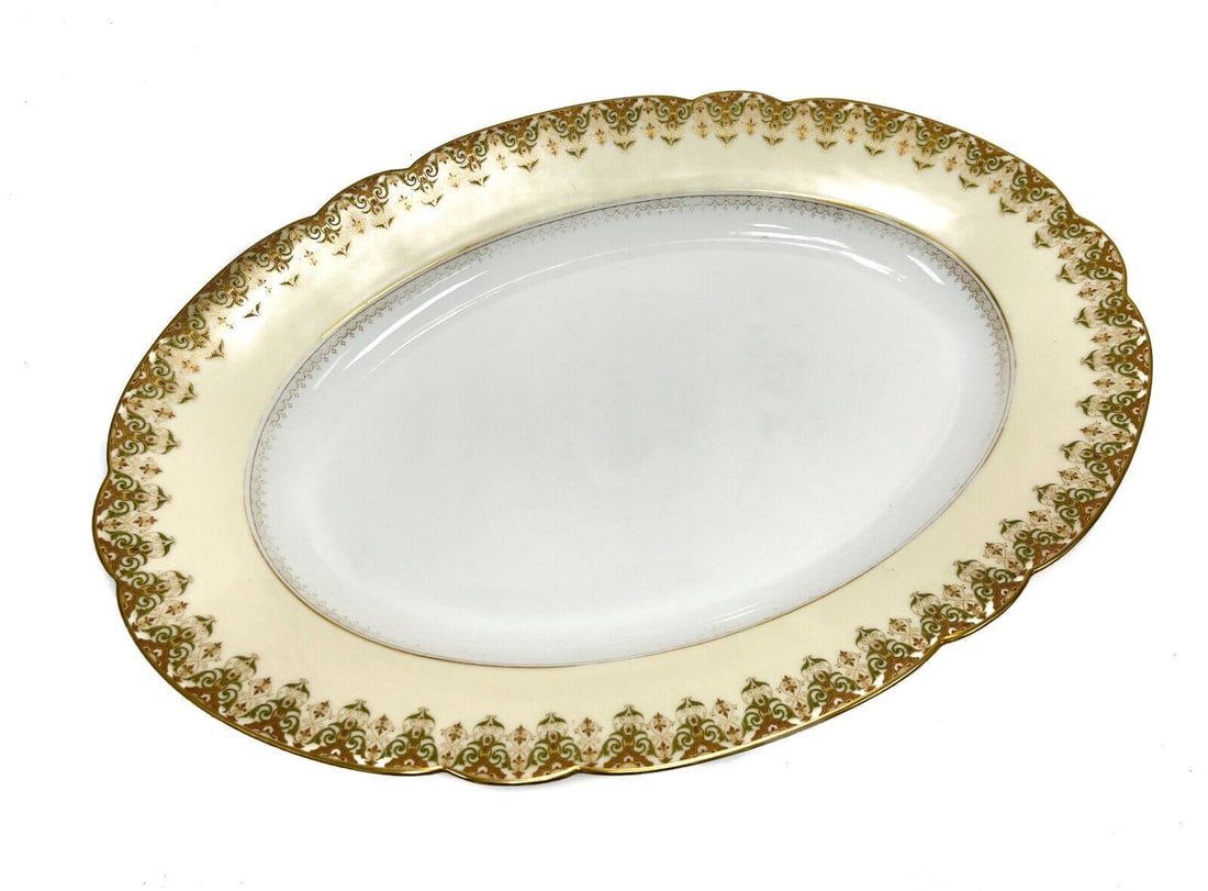 Limoges France Porcelain Large Scalloped Edge Serving Tray: Limoges France porcelain large scalloped edge serving tray. A pale yellow ground with green and gilt foliate scrolls to the scalloped rims. Limoges France mark to the underside base. Weight: Approx. 4