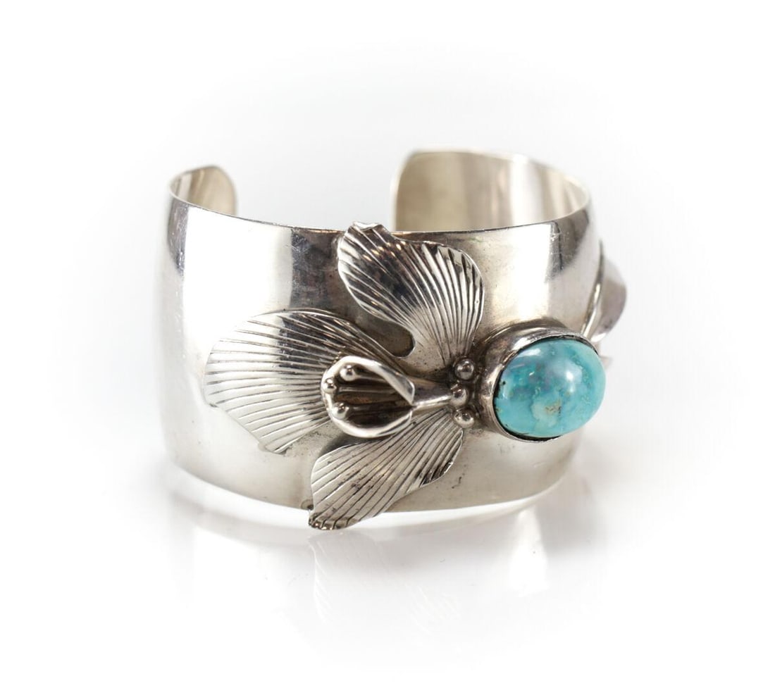 Vintage Sterling Silver Turquoise applied Iris Flower Cuff Bracelet Hand Chased: Vintage Sterling Silver Turquoise applied Iris Cuff Bracelet. Stunningly hand chased floral design with large oval turquoise cabochon. Marked Sterling, 58.3grams Measurements: Approx. stone 13mm x 17m
