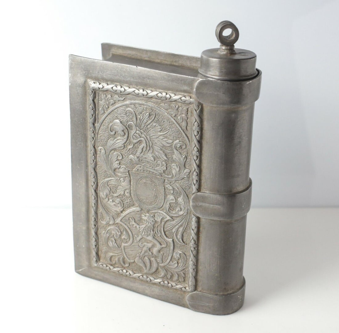 19th Century Continental Pewter Flask Renaissance style Faux Book Hand chased: 19th Century Continental Pewter Flask Faux Book, Handchased Renaissance style scrolls, armorial, rampant lion. Touch mark on base and on lid. 2.4lb Measurements: Approx. 5.5 x 2 x 7.5 inches Condition