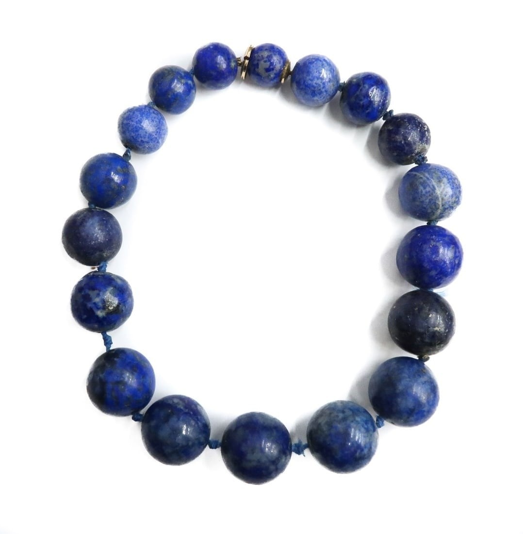 14k Yellow Gold Graduated Lapis Lazuli Beaded Necklace: 14k Yellow Gold Graduated Lapis Lazuli Beaded Necklace. The Lapis Lazuli beads measures from 14.8mm to 20.3mm. Clasp tests for 14k gold. Weight: Approx. 158 grams Measurements: Approx. 14 inches lengt