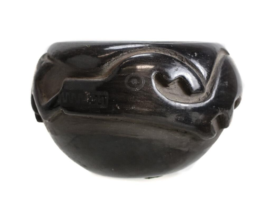 Blue Corn (1920-1999) San Ildefonso Pueblo Pottery Jar Avanyu water serpent: Blue Corn, "Crucita Calabaze (1920 - 1999) San Ildefonso Pueblo Pottery Jar, Avanyu water serpent, signed Blue Corn San Ildefonso Pueblo. Deeply carved design. 1lb. San Ildefonso is a small Tewa-speak