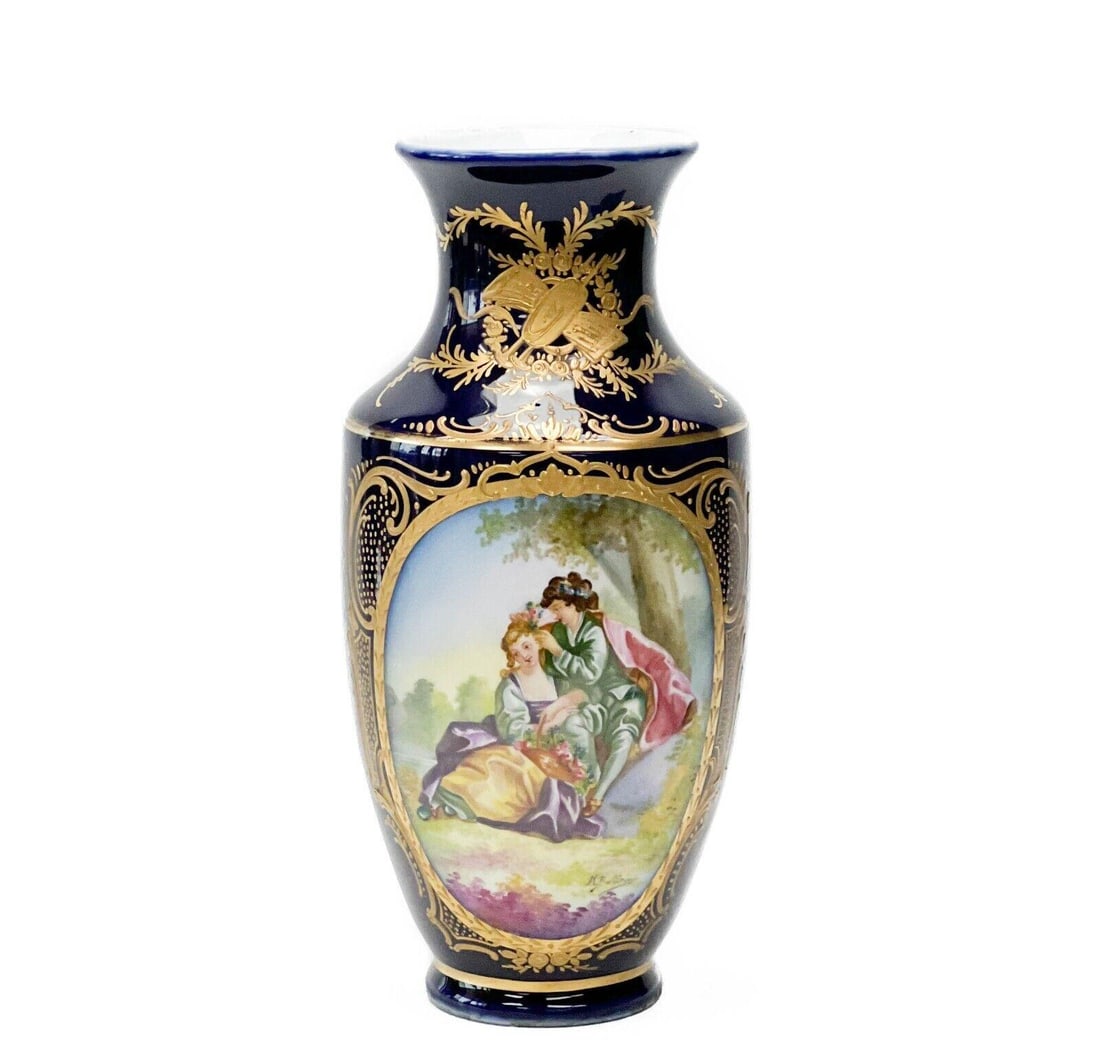 Manner of Sevres Hand Painted Porcelain Vase Artist Signed c. 1920: Manner of Sevres porcelain vase, circa 1920. A cobalt blue ground with raised gilt floral and foliate decoration. Hand painted image of a courting scene to one side, a landscape scene to the other. Ar