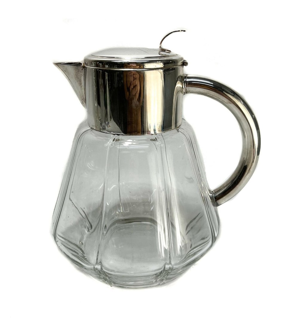 Large Silverplate and Cut Glass Water Pitcher with Strainer: Large silver plate and cut glass water pitcher with strainer. Unmarked. Weight: Approx. 2.5 lbs Measurements: Approx. 8 inches diameter x 10 inches tall Condition: Very good condition. Scratches to th