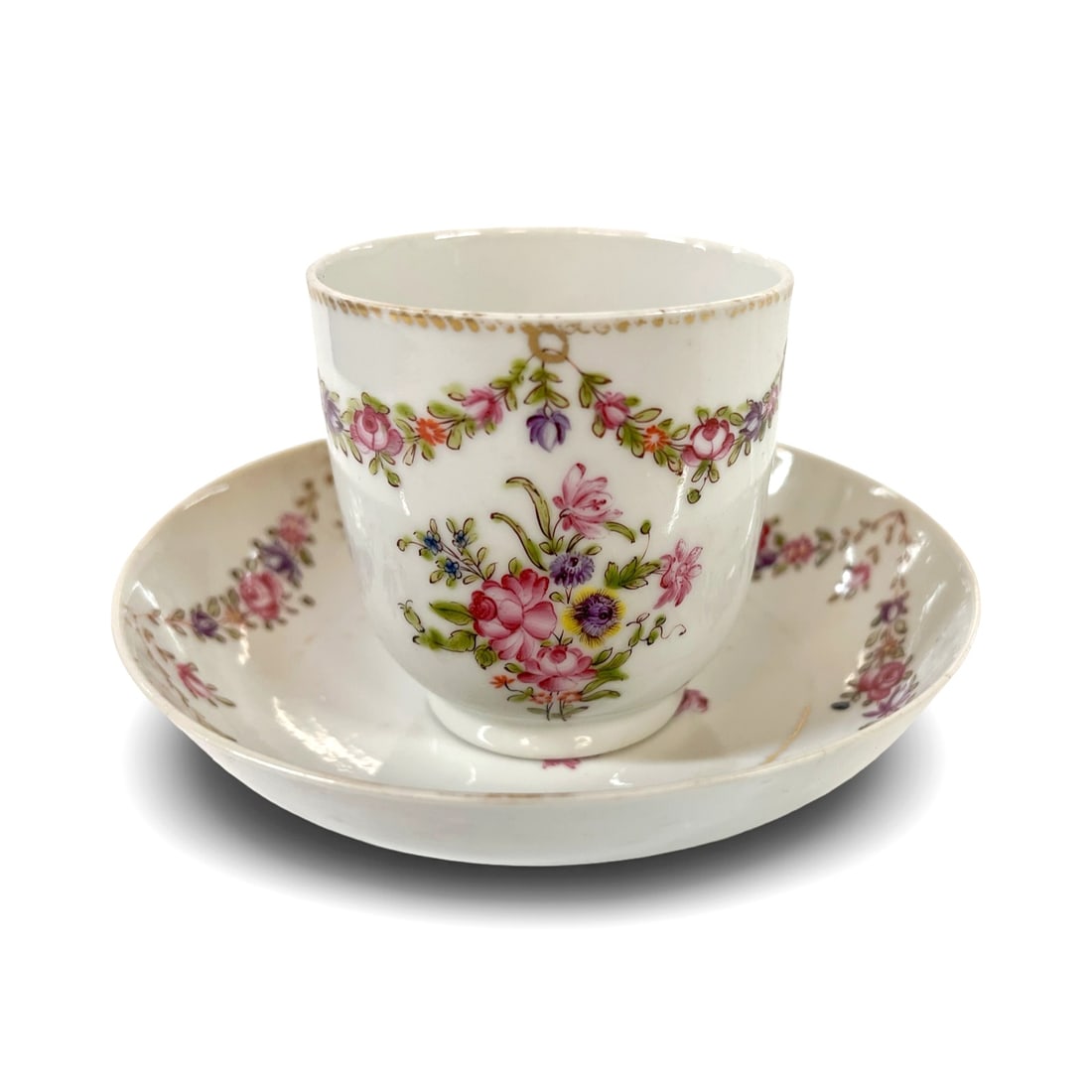 18th century Chinese export porcelain tea cup and deep saucer: 18th-19th century Chinese export tea cup and deep saucer, hand painted florals and floral swags. Gilt details. Measurements: Approx. saucer 5.25 x 1.25 inches; cup 3.625 x 2.625 x 2.75 inches height C