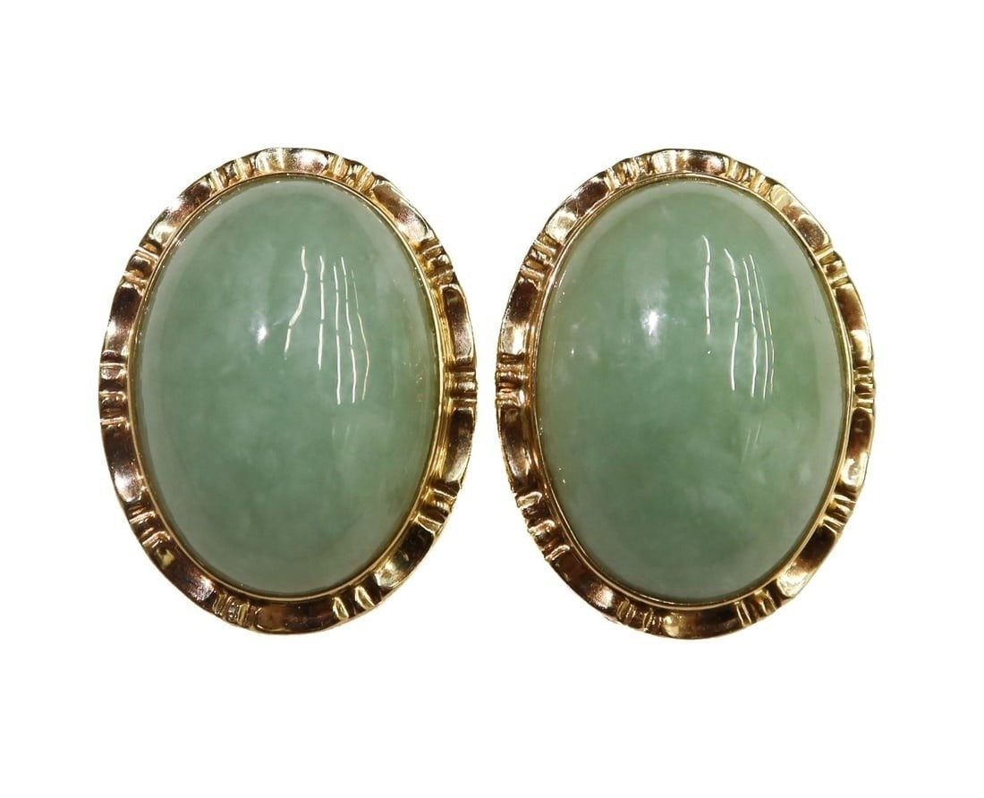 14k Yellow Gold Cabochon Jade Bezel Earrings: 14k Yellow Gold Jade Bezel Earrings. Cabochon oval jades measuring approximately 17.9mm x 12.7mm x 6.1mm. Marked 14k. Weight: Approx. 9.39 grams Measurements: Approx. 0.8 inches x 0.6 inches x 0.75 in