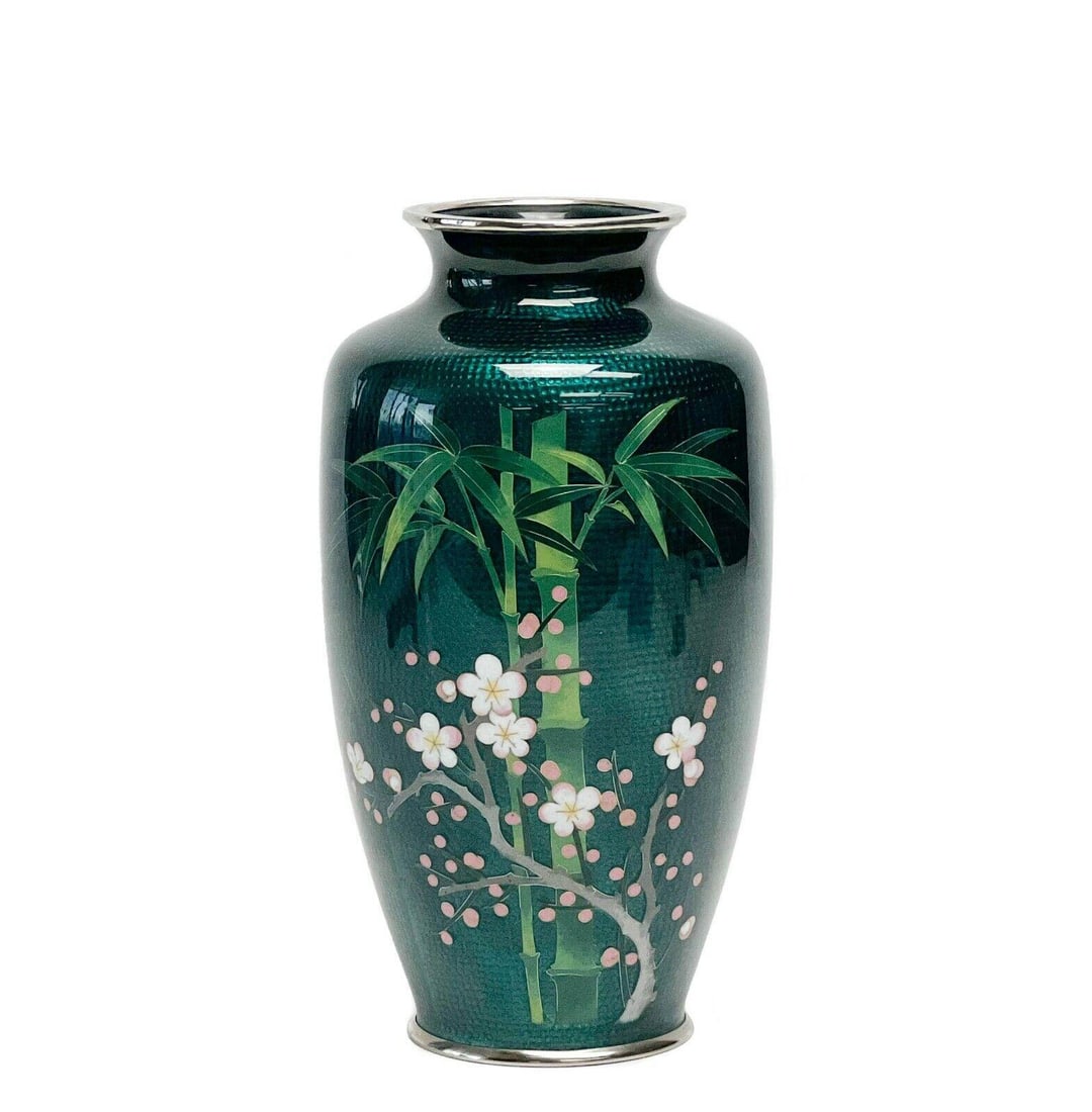 Japanese Sato Cloisonne Enamel Green Bamboo Vase: Japanese Sato Cloisonne enamel green bamboo vase. A green textured ground with bamboo and pink cherry blossom decoration to the front. Underside mount marked Japan Sato Cloisonne. Weight: Approx. 1