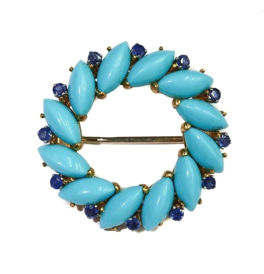 18k Yellow Gold Turquoise and Blue Spinel Round Brooch: 18k Yellow Gold Turquoise and Blue Spinel Round Brooch. 12 oval cut turquoise with alternating round cut blue spinels weighing approximately 0.6 carats. Marked 18k to edge. Weight: Approx. 7.20 grams