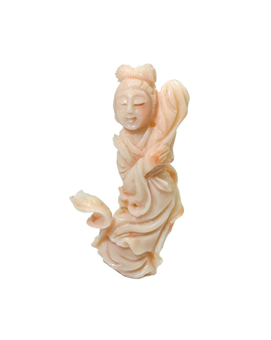 Carved Pink Coral Diety Figure of Guan Yin: Carved Pink Coral Diety Figure of Guan Yin. Weight: Approx. 24.89 grams Measurements: Approx. 2.6 inches x 1.325 inches x 0.5 inches tall Condition:Minute chips to edge. Please refer to photos. Domest