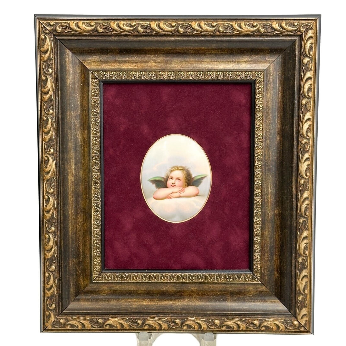 German Hand Painted Porcelain Portrait Plaque Raphael Sistine Cherub Framed: German Hand Painted Porcelain Portrait Plaque, early 20th century. Oval shaped plaque depicting one of Raphael's cherubs. Mounted in a gilt wood frame, red fabric lining. Weight: Approx. 3 lbs Measure
