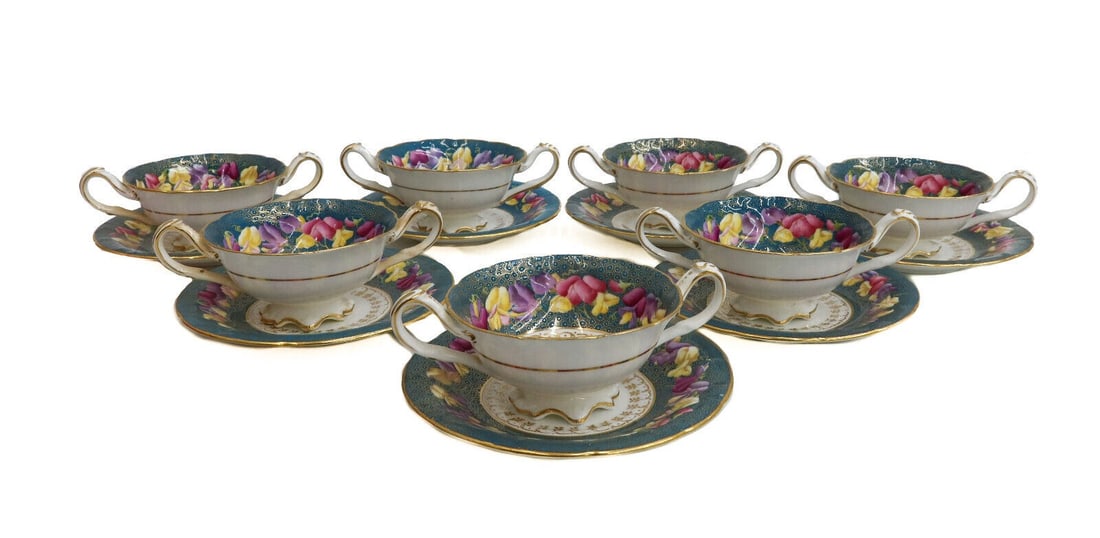 7 Cauldon England Porcelain Bouillon Cups & Saucers. Late 19th to 20th Cen: 7 Cauldon England porcelain Bouillon cups & saucers ranging from the late 19th century to early 20th century. Teal ground with gilt dot pattern and colorful flowers. Gilt floral pattern to center edge