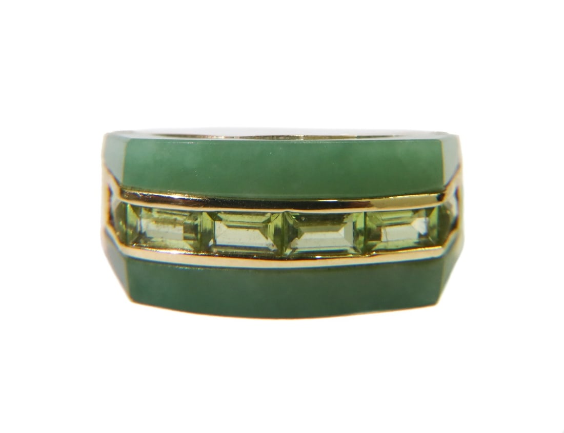 14k Yellow Gold Green Jade and Baguette Cut Peridot Ring Size 7.5: 14k yellow gold green jade and peridot ring, size 7.5. Jade band to face with baguette cut peridots to center measuring around 4.92mm x 3.3mm x 1.31mm. Marked 14k. Weight: Approx. 6.07 grams Measureme
