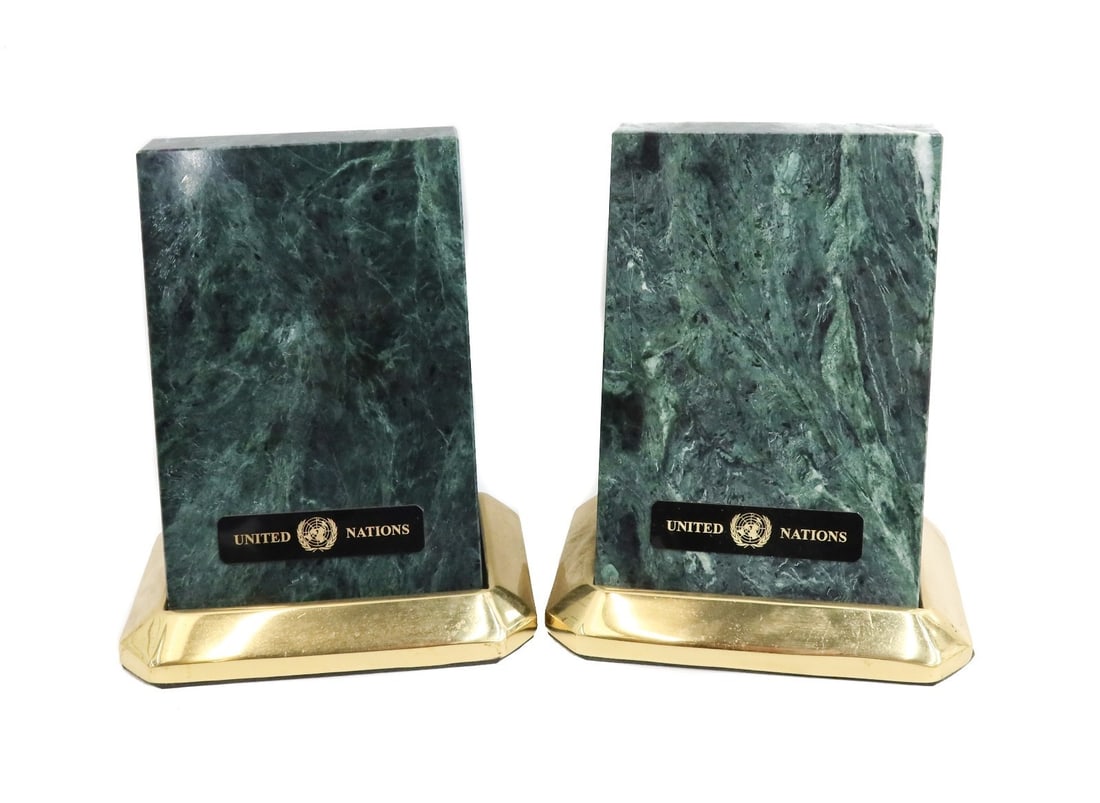 Pair Green Marble Stone & Bronze United Nations Bookends Present to Joan Rivers: An attractive and substantial pair of United Nations branded bookends with green marble stone and gilt bronze, probably 3rd quarter 20 Century. Purportedly gifted from the United Nations to Joan River