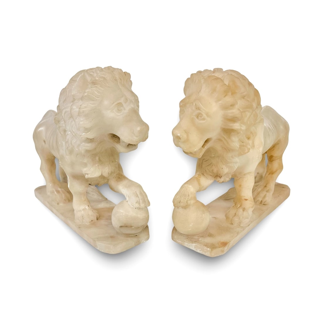 Pair of Italian Grand Tour carved alabaster Medici Lions: A pair of Italian Grand Tour carved alabaster Medici Lions, c late 19th century. Two male lions, with one paw on an orb. After the antique original, sited at the Loggia Dei Lanzi, Piazza Della Signori