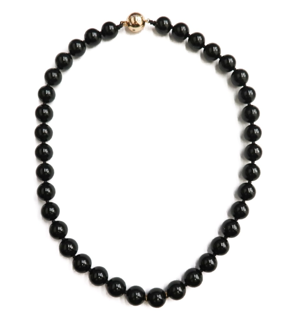 14k Yellow Gold Diamond and Beaded Onyx Single Strand Necklace: 14k yellow gold diamond and beaded onyx single strand necklace, attributed to Gump's. 37 onyx beads measuring approximately 11.84mm. Ball clasp with various round cut diamonds throughout weighing appr
