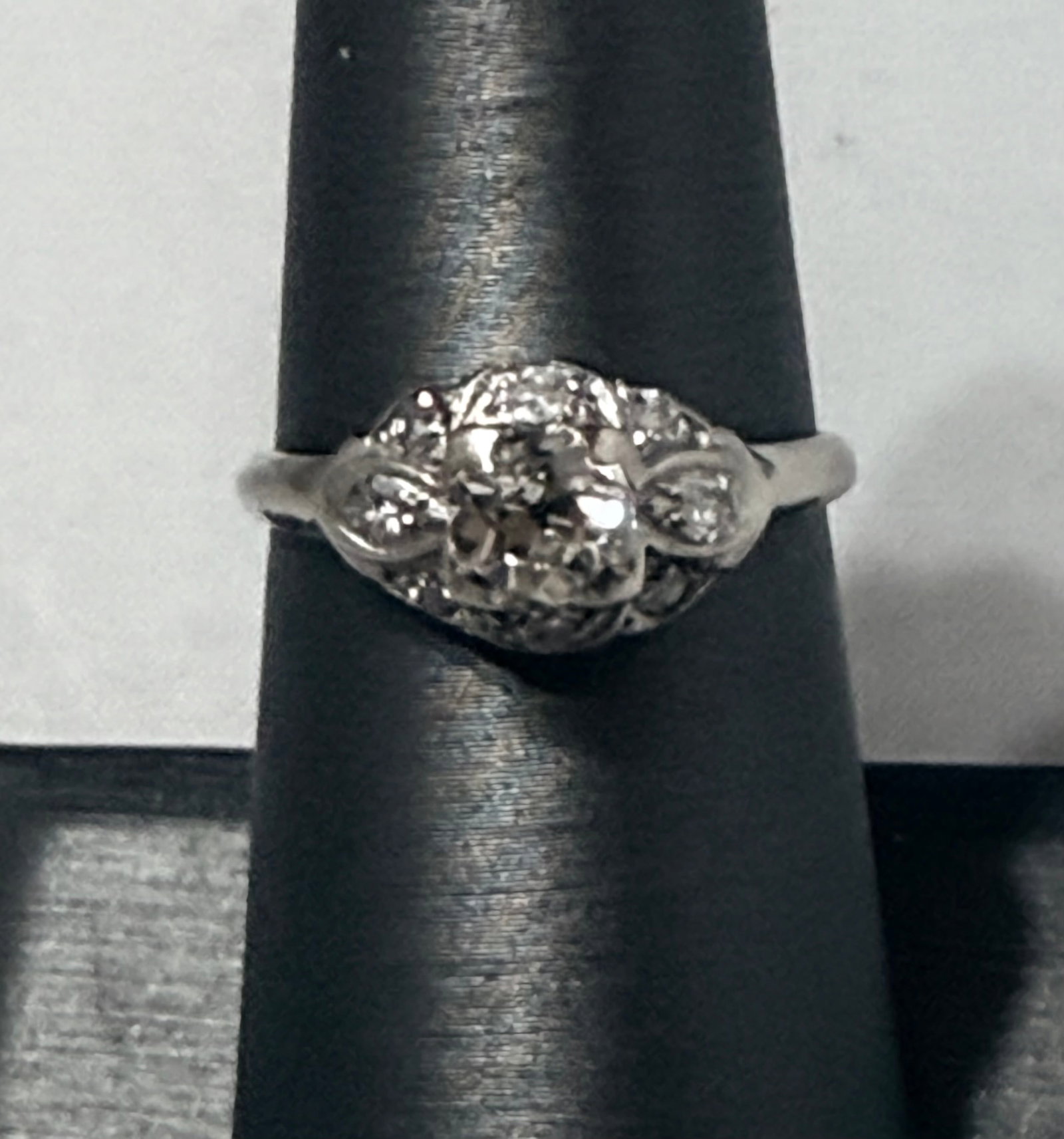 14k White Gold Vintage Ring with Mine-Cut Diamond – Approx. 0.66ct – Size 7: This 14k white gold vintage diamond ring showcases a beautifully hand-crafted design reminiscent of early 20th-century American artistry. At its center rests a mine-cut diamond weighing approximately 